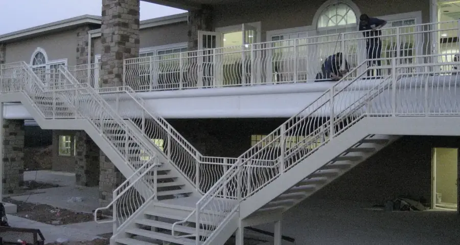 A black picket railing on a boat dock over Lake Conroe
